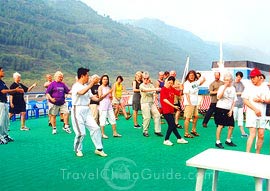 Practicing Tai Chi on the deck following teacher's act.