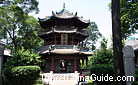 A foreigner reading a book in front of the Shen Xin Tower in the Great Mosque.