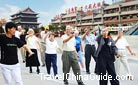 A Chinese coach is teaching foreigners to play Tai Chi Quan.