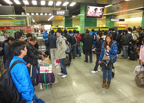 Passengers queue up to buy tickets from Self-service Ticket Machines. 