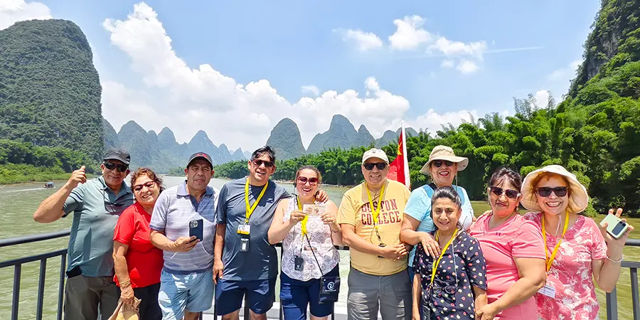 Visitors viewing the beautiful scenery of Li River on the cruise ship