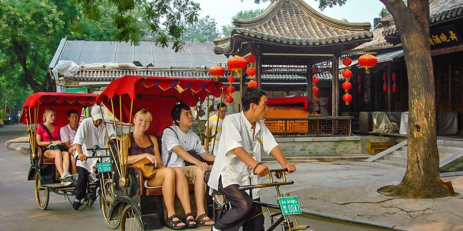 Tourists traveling by rickshaw