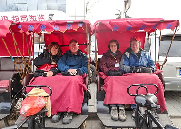 Tourists traveling by rickshaw