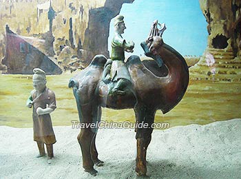 Statues of travelers on ancient silk road