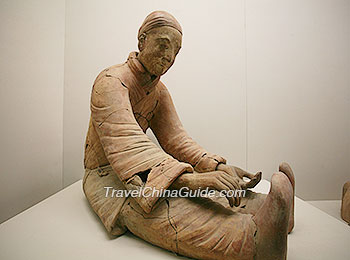Terracotta Figure with stretching arm in sitting position