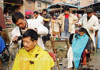 Local people get a haircut at market 