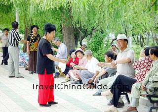Chinese people greets each other in a park
