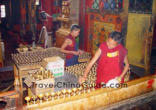 Monks fill butter in the Butter Lamps