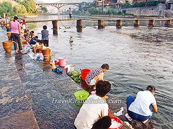 Local people wash clothes at the bank of Tuojiang River 