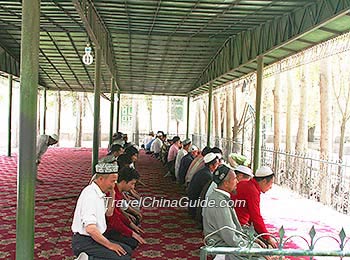 Uygur people make a prayer in a mosque.