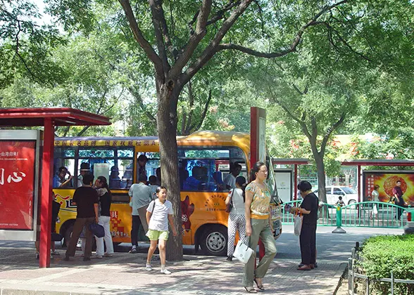 People queue up to get on the bus.