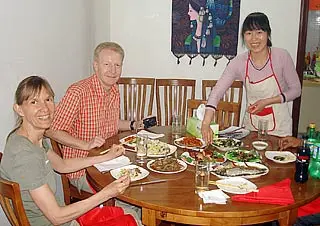 Mr. Heinz Johner & Ms. Jeannette Johner Having Meal in a Local Family