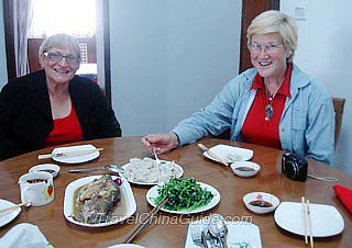 Ms. Bobbye S Underwood & Ms. Carol Ann Holliday Having Meal in a Chinese Family