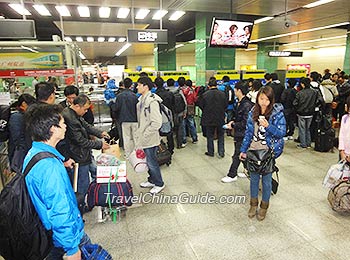 Passengers queue up to buy tickets from Self-service Ticket Machines. 