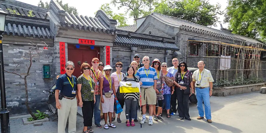 Our tourists in front of a local house at Beijing Hutong