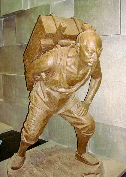 A laborer carrying stones