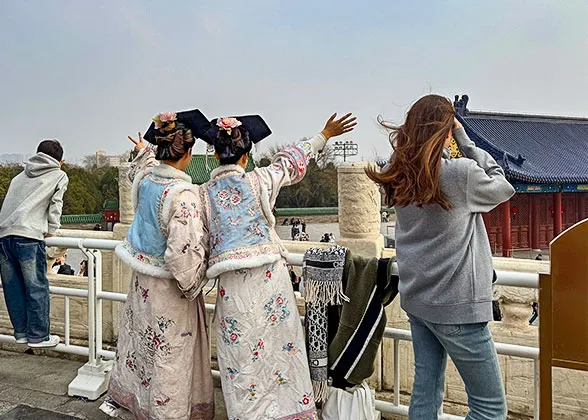 Visitors on Red Stairway Bridge
