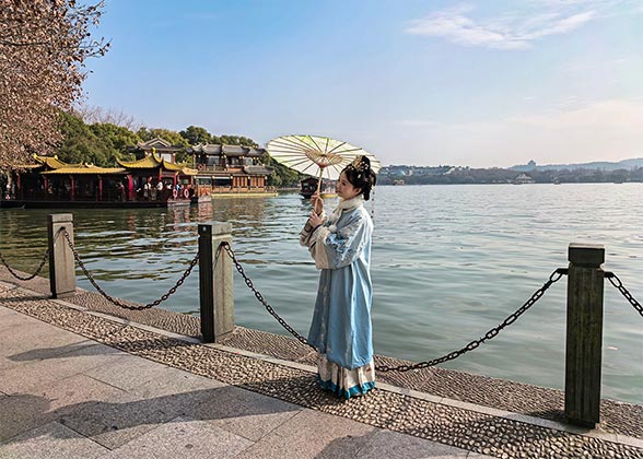 Tourist Taking Photos by West Lake